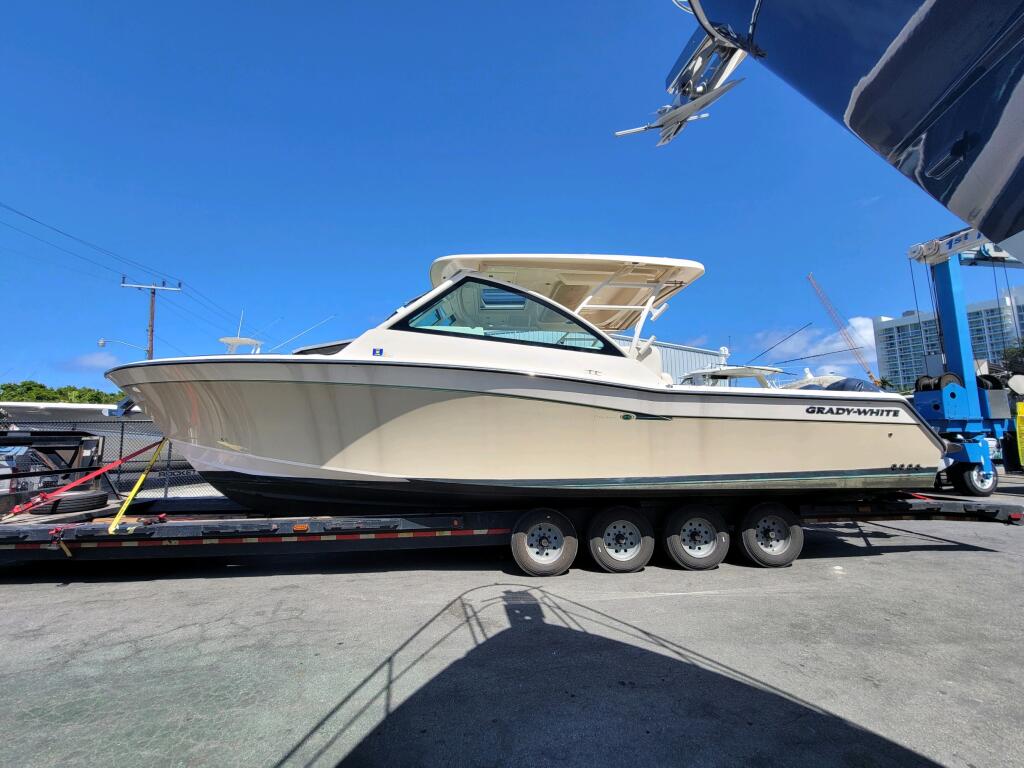Boat on multi-axle trailer at haul-out facility